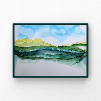 Layers of green mountains with a blue sky