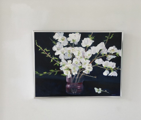 The painting’s dark background shows off the blossoms. The single stem on the table is a horizontal touch to offset the vertical flower stems.