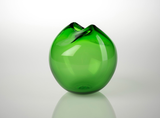 Round green glass object with 'pinched' slot opening