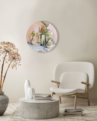 Four vases with flowers sitting on lace. 