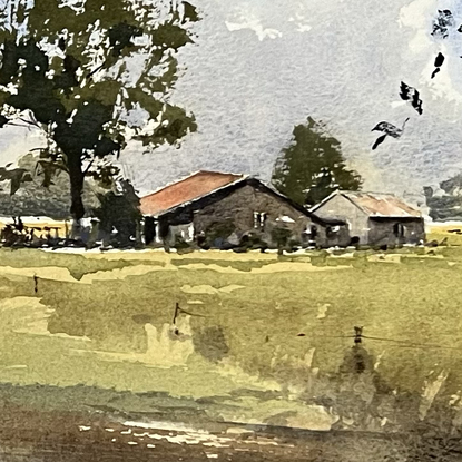 A farm house and a big tree in the distance and a silhouette of tree branches and scrub in the forground.