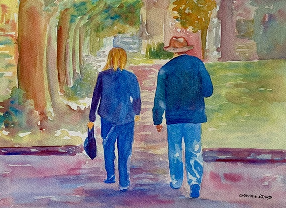 Man and a woman walk in a shady spot.