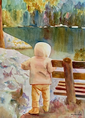 Child stands by a wooden bench.