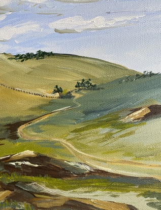 This country landscape depicts olling green hills and a row of trees, a winding dirt track and rocky outcrops under a hazy blue sky. 