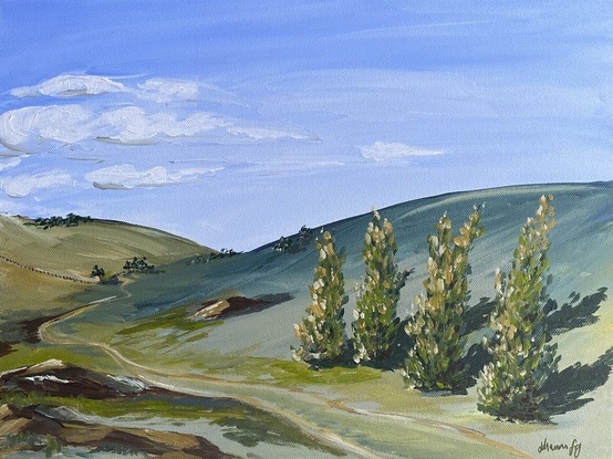 This country landscape depicts olling green hills and a row of trees, a winding dirt track and rocky outcrops under a hazy blue sky. 