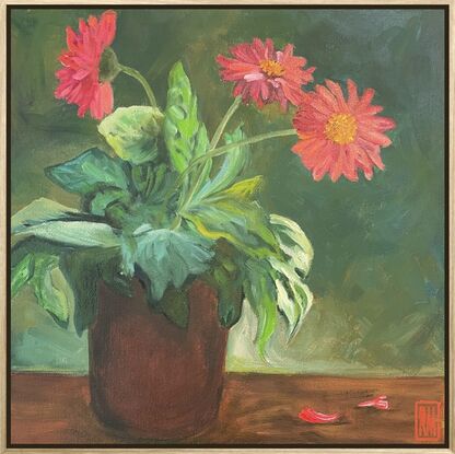 A terracotta planter pot is in the middle of the canvas filled with a Gerbera plant.  The lush green leaves spill over the edge of the pot while three arching stems hold large, red flower heads.  The background is painted in shades of brown and green.