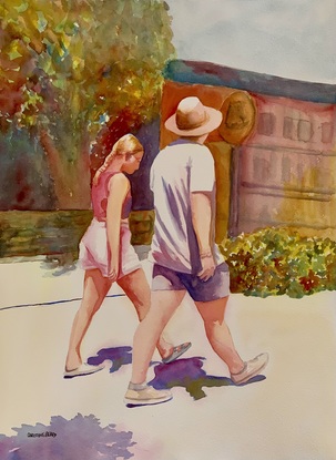 A couple walks in the street.