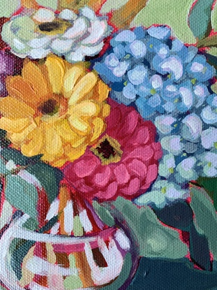 Zinnias and Eucalypt leaves in a glass vase