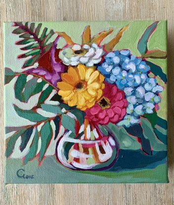 Zinnias and Eucalypt leaves in a glass vase