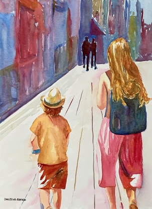 Woman and boy walking up the street.