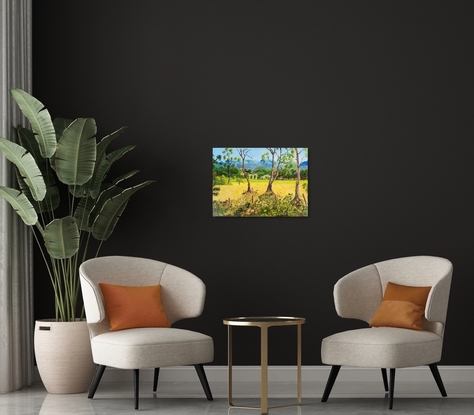 a painting of a field of golden pastures interspersed with shrubs and gum trees with the rugged cliffs in the background, with undulating slopes and a rugged fence line in the midst with cows going about their  daily routine looking for something to munch on.