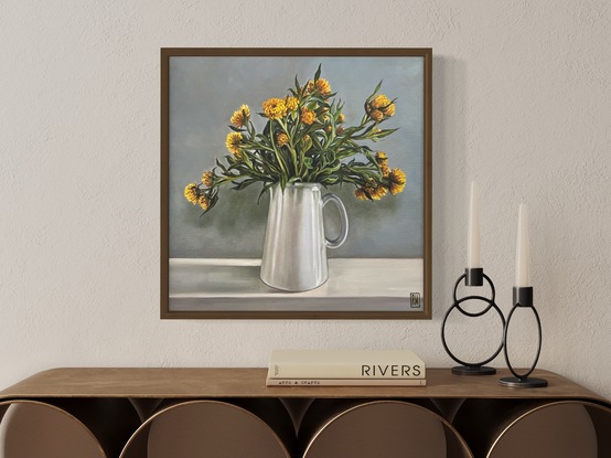 A square canvas frames a large bunch of yellow straw flowers nestled in a white pottery jug.  There are many intertwining leaves and stems.  Light comes from the right hand side casting shadows on the wall and mantle where the jug sits and turning the light grey wall bluish green.