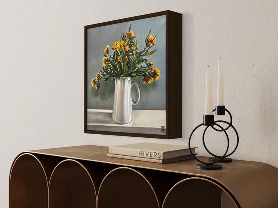 A square canvas frames a large bunch of yellow straw flowers nestled in a white pottery jug.  There are many intertwining leaves and stems.  Light comes from the right hand side casting shadows on the wall and mantle where the jug sits and turning the light grey wall bluish green.