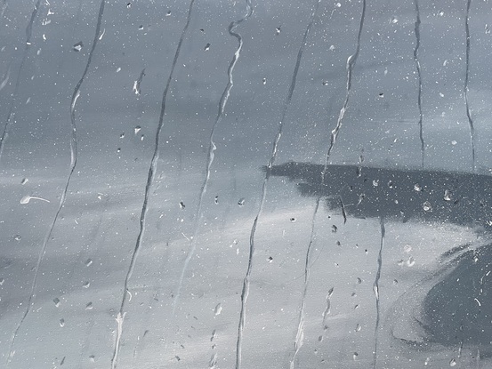 Monochrome raindrops on glass