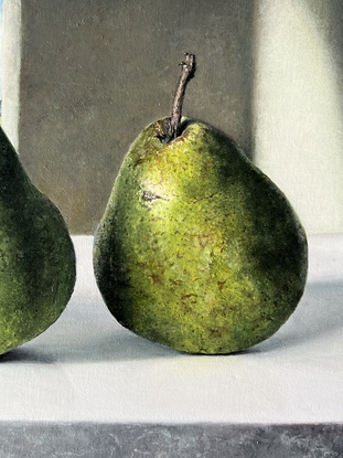 four green pears with dark background