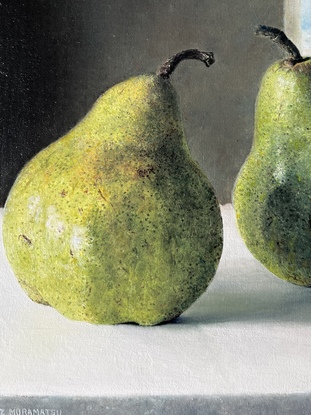 four green pears with dark background