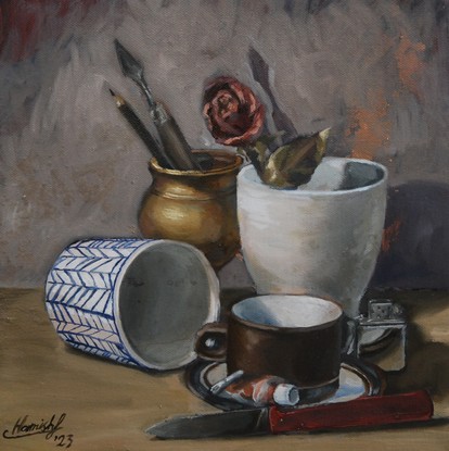 A cluster of objects, featuring a cup and saucer, an overturned cup, a large coffee mug, a spent tube of paint, a zippo lighter, a palette knife, a pencil, a dried rose and an old style folding pocket knife. The lighting is balanced and the background looks almost misty and ethereal, contrasting the detailed rendering of the subject matter.  