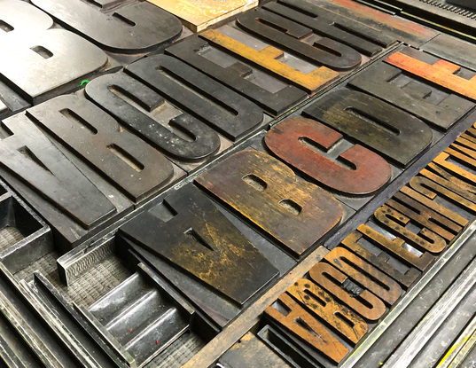 
The vibrant colour palette of yellow, red, black and silver bring the large format letterpress  print to life.  