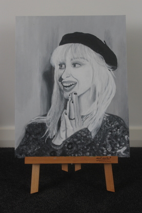 A black and white portrait of Hayley Williams (Paramore).