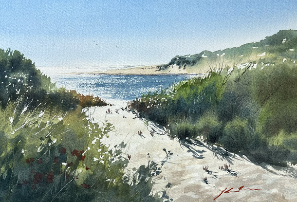 A sandy track bordered by bush scrub leads to the sparkling Margaret River. The beach scrub dominate the foreground.