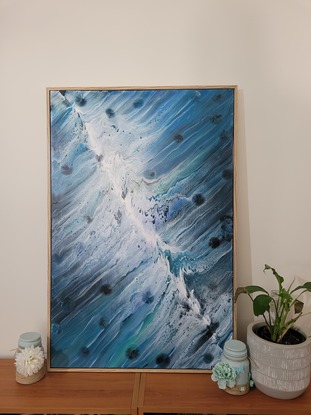 This is a 90cm x 60cm acrylic pour painting using swipe technique.  Painting has had clear acrylic spray over top to protect painting.  Art work is framed with wood backing and is ready to hang.