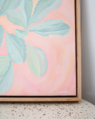 Turquoise banksia leaves on colourful pink background of organic brushstrokes