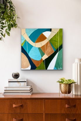 A n abstract painting using the colours of the coast line  think blues, greens and the colour of warm sand. The painting consists of layers of geometric shapes that all connect together. I have used etched patterns into different shapes. It is my interpretation of a Birds Eye view of the beach. 