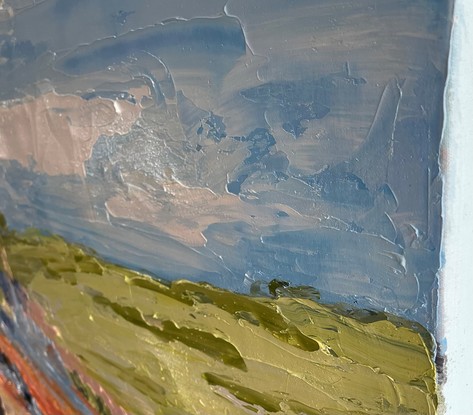 A creek runs through this painting surrounded by rocks, gum trees, green hills and a blue sky.