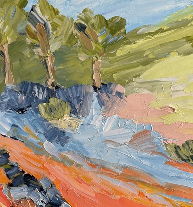 A creek runs through this painting surrounded by rocks, gum trees, green hills and a blue sky.