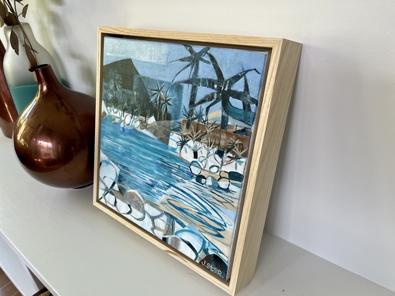 Beach scene with rocks and palms.