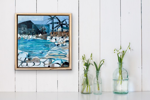 Beach scene with rocks and palms.