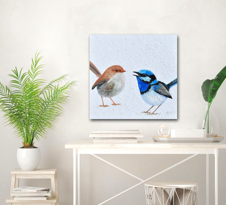 A thickly textured painting of two Superb Fairy Wrens on a white painted background. One, a brown female and the other a brilliant blue male.