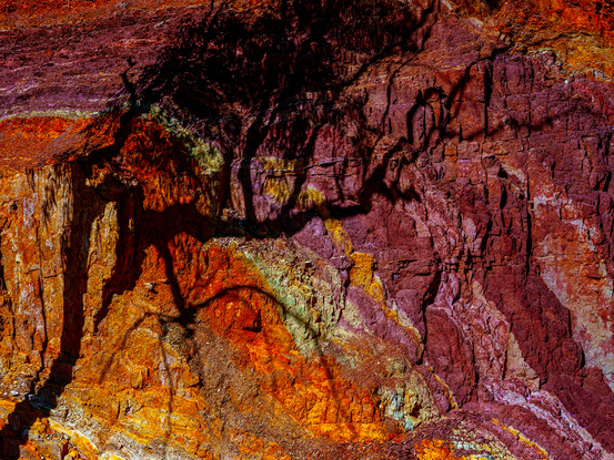 An Australian outback landscape with ochre colours and a eucalyptus tree casting a shadow.