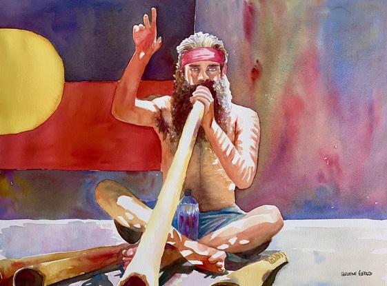 Musician plays his harmonic and rhythmic didgeridoo.