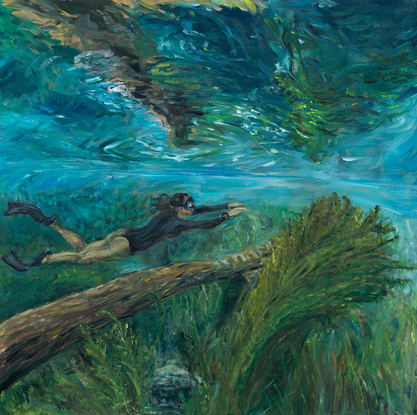 Diver swimming through an underwater landscape