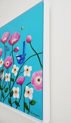 A group of happy pink poppies and smaller white flowers against a turquoise background. The poppies have open happy faces and a splendid blue wren and its mate relax on the stems of the poppies. A dragonfly rests on another stem and three litte bees hover between the flowers looking for nectar. The colours are largely turquoise, pink, white, blue and some yellow. The painting is framed in a white box frame.