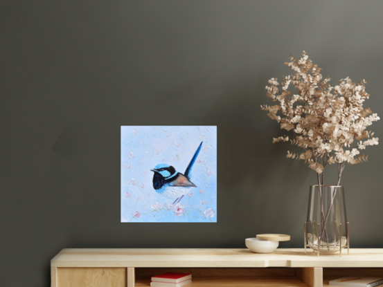 Thickly textured oil painting of a Superb Fairy Wren perched on a blossom branch. 