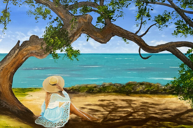 Female on the beach under the big tree