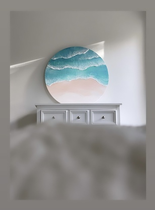 Round canvas depicting the shoreline. 
Both light and dark blues with waves crashing along the shore. 
Soft sands and dreamy elements. 
A truly coastal beauty 