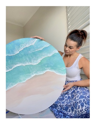 Round canvas depicting the shoreline. 
Both light and dark blues with waves crashing along the shore. 
Soft sands and dreamy elements. 
A truly coastal beauty 