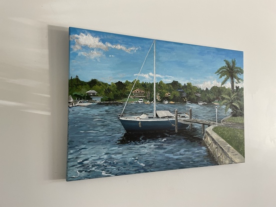 Sail boat docked at jetty on sunny day