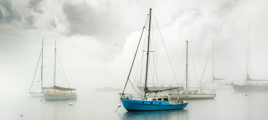 A blue boat captured in heavy fog at Williamstown Beach by the photographer.