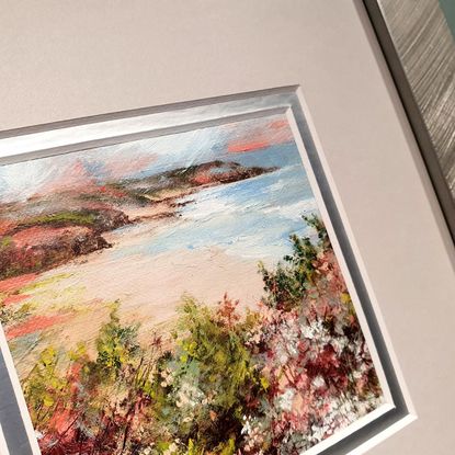 Mini oil painting of heathland above a distant seascape, in muted olive, silver tones and crimson reds. Framed in silver. 