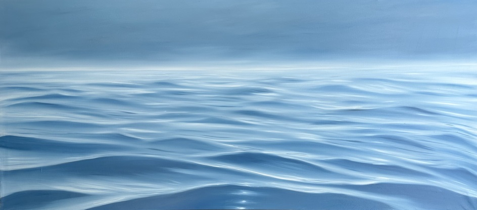 Ocean ripples under a dark grey sky