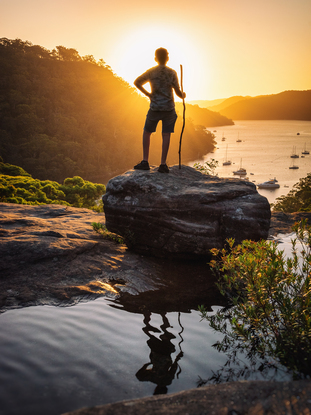 Boy at sunset on cliff top