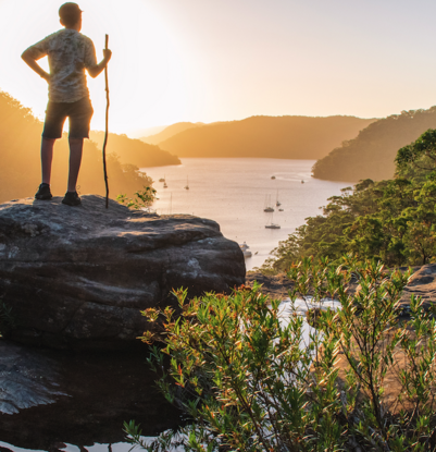 Boy at sunset on cliff top