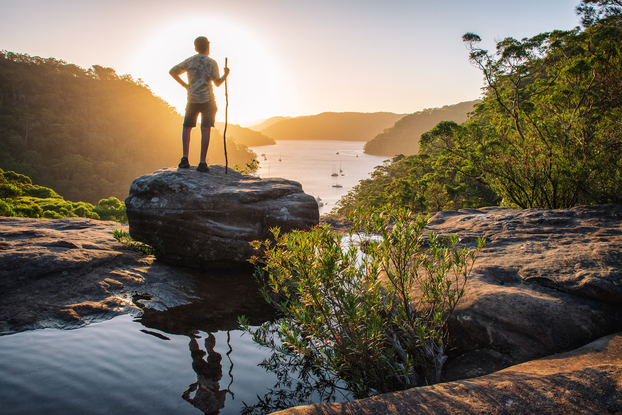 Boy at sunset on cliff top