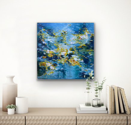 Soft dreamy blues and dashes of yellow and orange abstract flowers that dance over the water on this canvas to create a dreamy watery world. You can feel the power of nature through the colour and the brushstrokes that tell a story of a colourful water garden spilling over with life and vibrancy. 