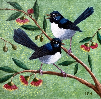 Two beautiful Willy Wagtails sitting on a eucalyptus tree with red and yellow gum blossoms. The background is a pale green speckled colour, with specks of yellow blossom sifting through the air.  The two birds appear to be in conversation.