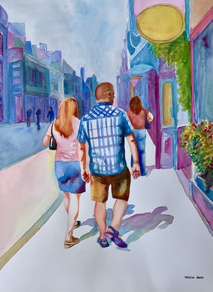 Couple walk along the high street.